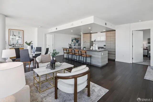 a dining room with furniture potted plants and wooden floor