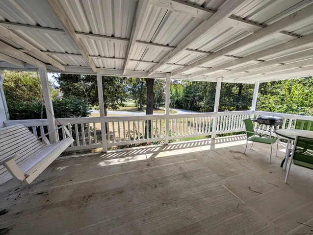 a view of a porch with furniture and garden