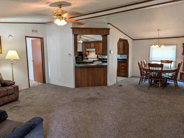 a view of a livingroom with furniture and a kitchen
