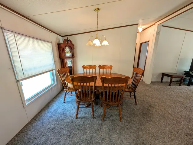 a view of a dining room with furniture and a window