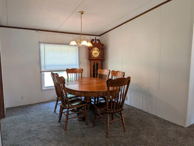 a view of a dining room with furniture and window