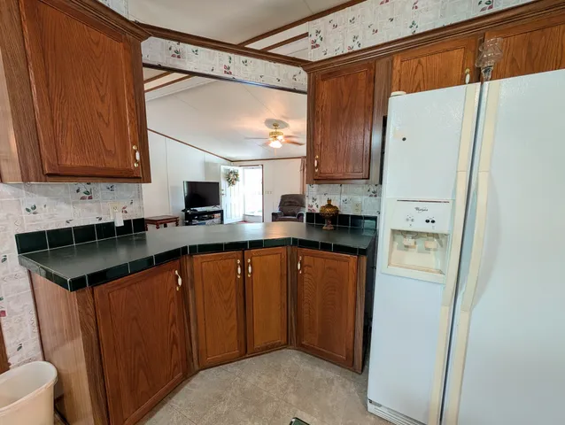 a kitchen with stainless steel appliances granite countertop a refrigerator sink and cabinets