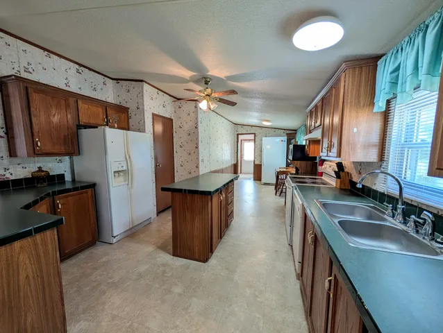 a kitchen with refrigerator cabinets and wooden floor