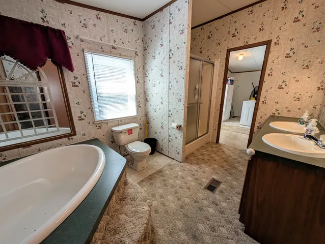 a bathroom with a tub sink and mirror
