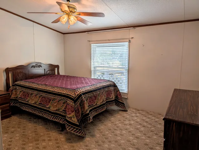a bed sitting in a bedroom next to a window