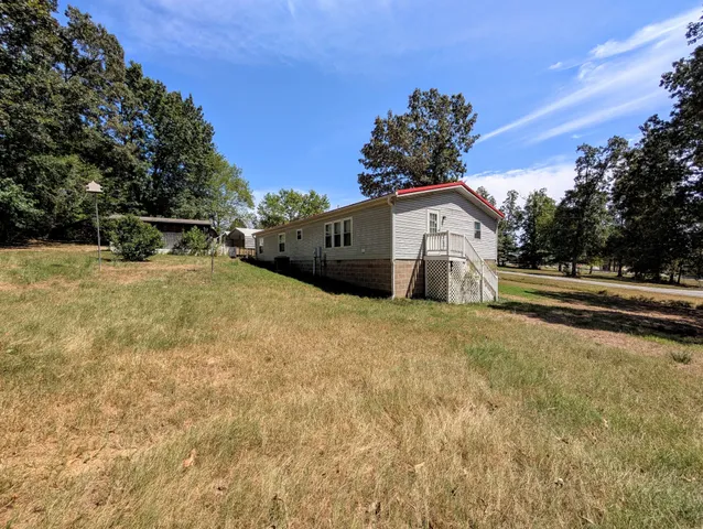 a view of a house with a snow in front of yard
