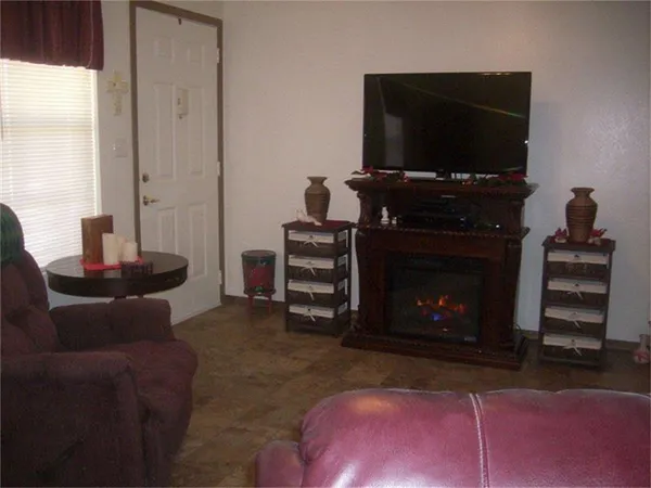a view of a livingroom with furniture and bathroom