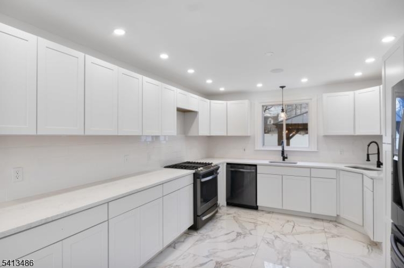 224 Swarthmore Road Linden, NJ 07036 - Photo 11 of 33 a kitchen with a sink white cabinets and stainless steel appliances