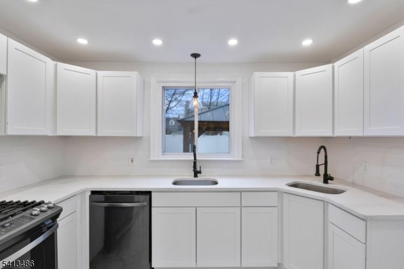 224 Swarthmore Road Linden, NJ 07036 - Photo 12 of 33 a kitchen with kitchen island granite countertop a sink stainless steel appliances and cabinets
