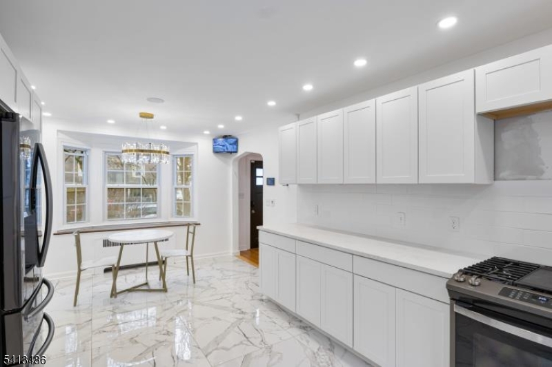 224 Swarthmore Road Linden, NJ 07036 - Photo 13 of 33 a kitchen with stainless steel appliances granite countertop a refrigerator and a stove top oven