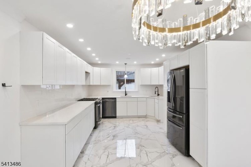 224 Swarthmore Road Linden, NJ 07036 - Photo 10 of 33 a kitchen with stainless steel appliances a refrigerator a stove a sink and a chandelier