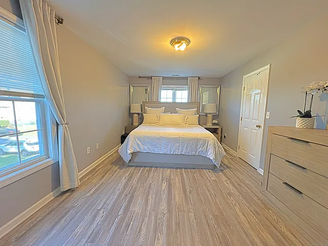 a bedroom with a bed and a large window