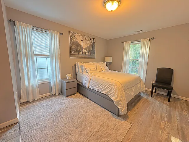 a bedroom with a bed and chair