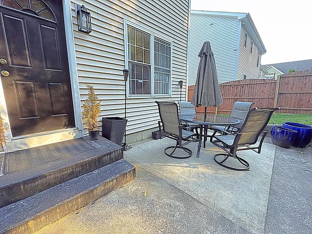 a view of a dinning table and chairs in the patio
