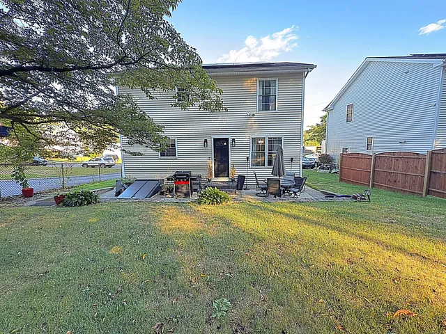 a view of a house with backyard and sitting area
