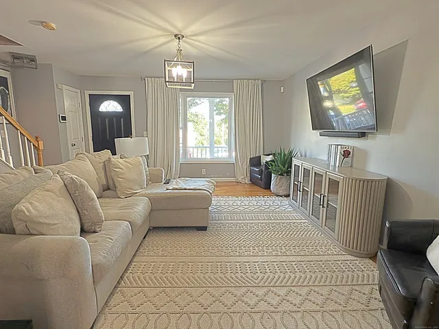 a living room with furniture and a flat screen tv
