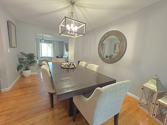 a view of a dining room with furniture and chandelier