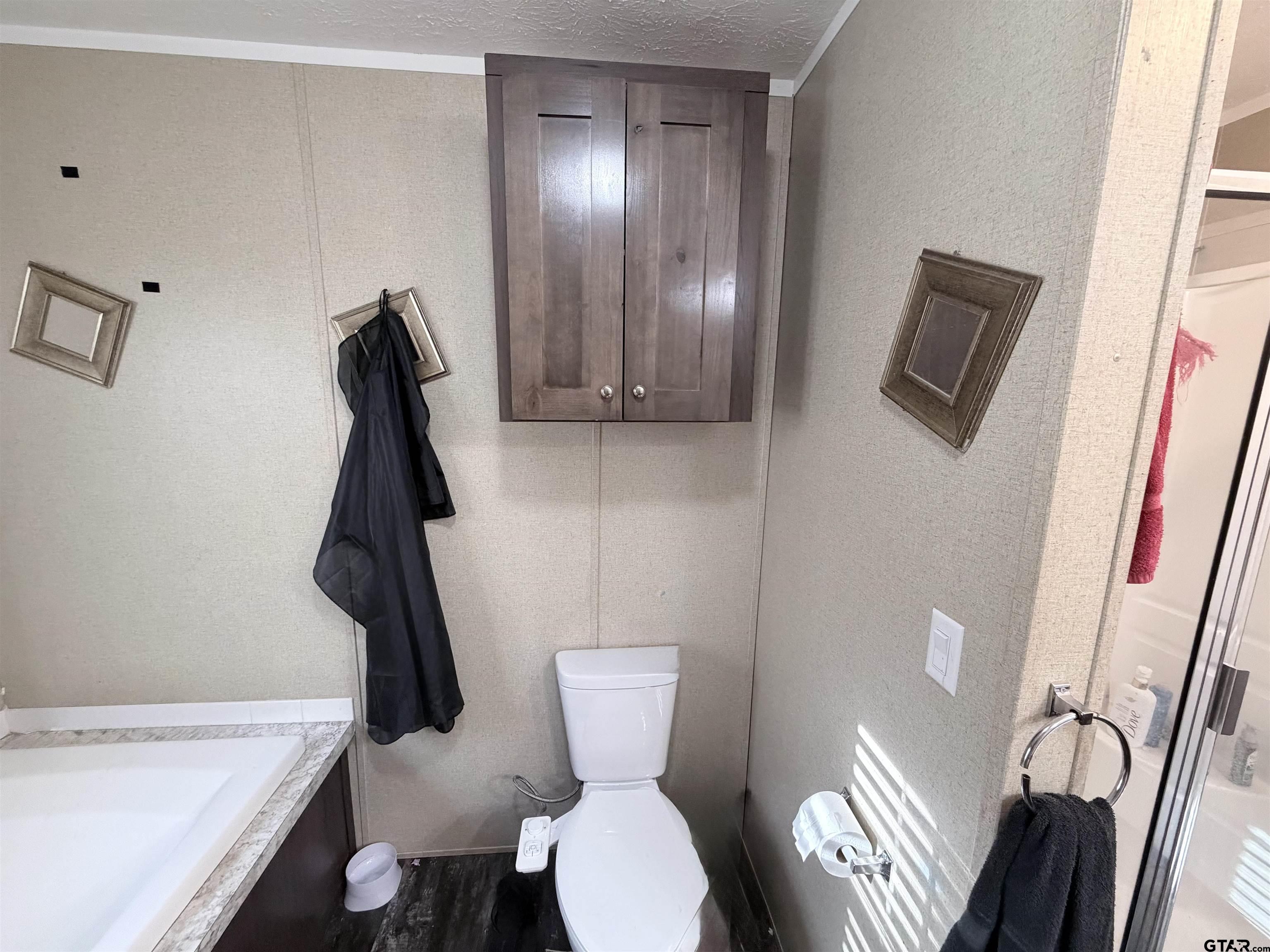 11300 Highway 271, Unit 52 Tyler, TX 75708 - Photo 11 of 16 a bathroom with a toilet and a sink