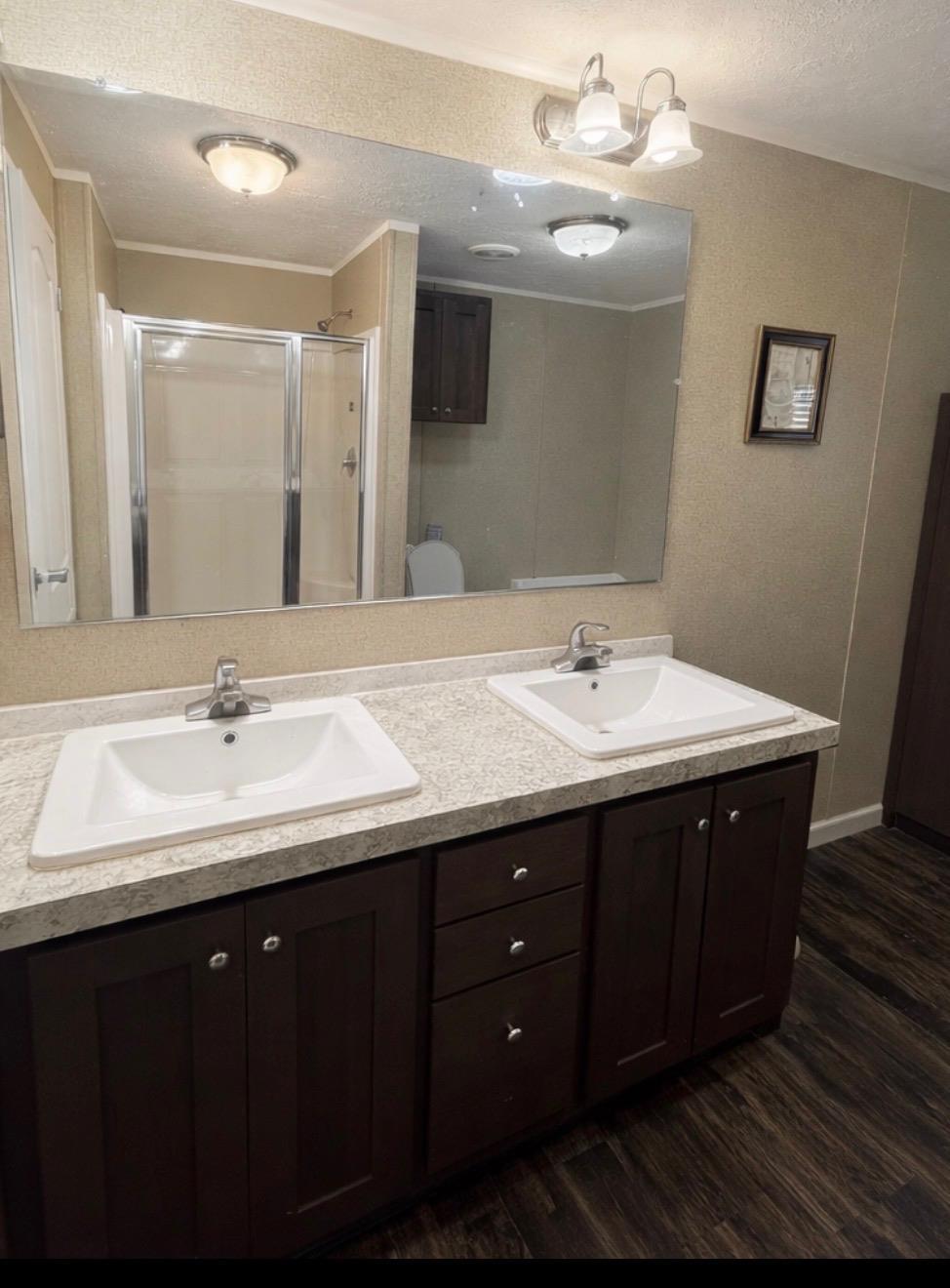 11300 Highway 271, Unit 52 Tyler, TX 75708 - Photo 14 of 16 a bathroom with a double vanity sink and a mirror