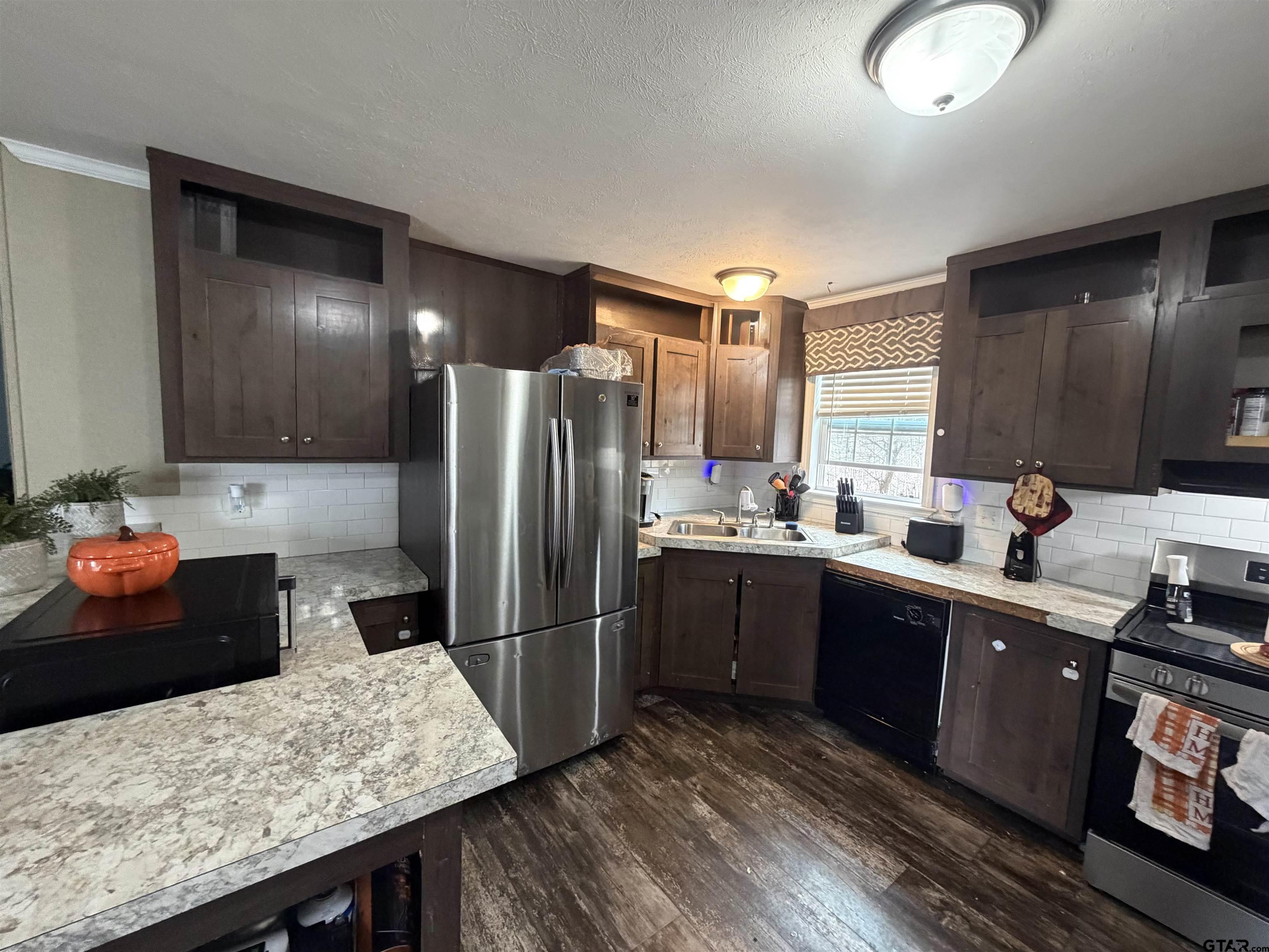 11300 Highway 271, Unit 52 Tyler, TX 75708 - Photo 2 of 16 a kitchen with stainless steel appliances granite countertop a refrigerator and stove