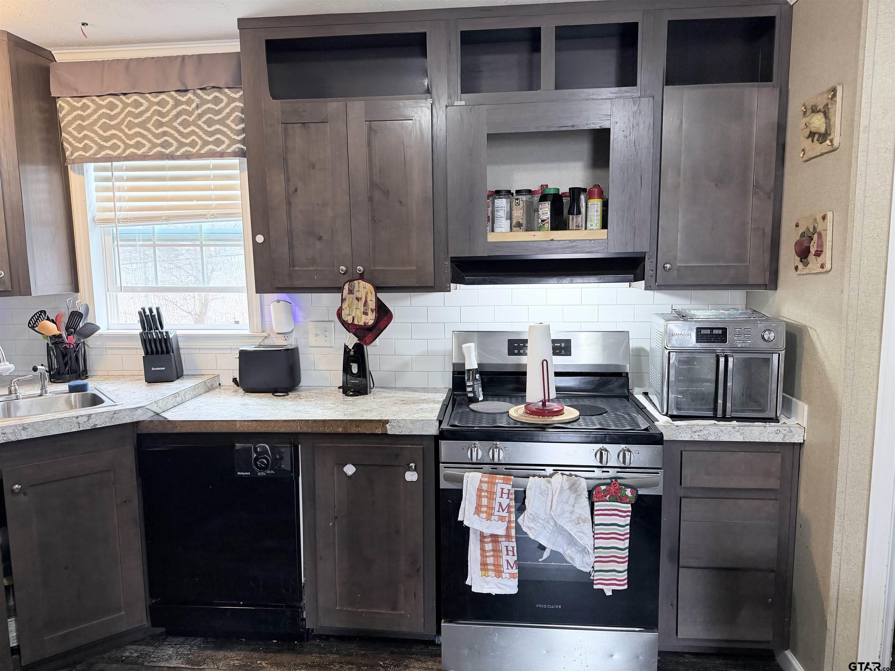 11300 Highway 271, Unit 52 Tyler, TX 75708 - Photo 4 of 16 a kitchen with stainless steel appliances granite countertop a sink stove and cabinets