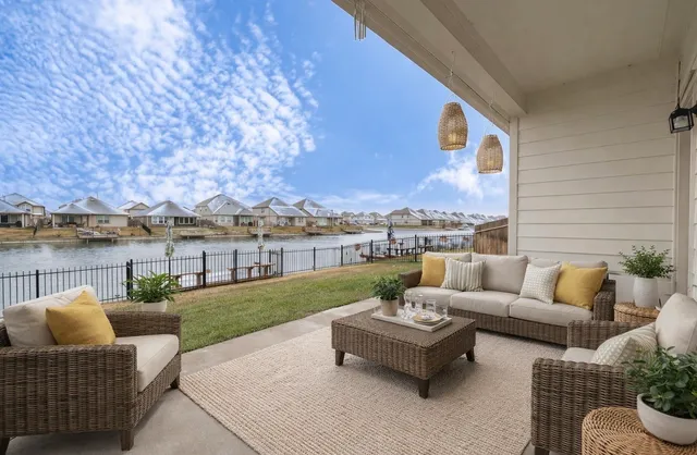 a roof deck with couches and potted plants