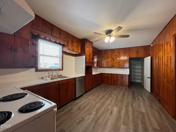 a kitchen with a stove a sink and a refrigerator