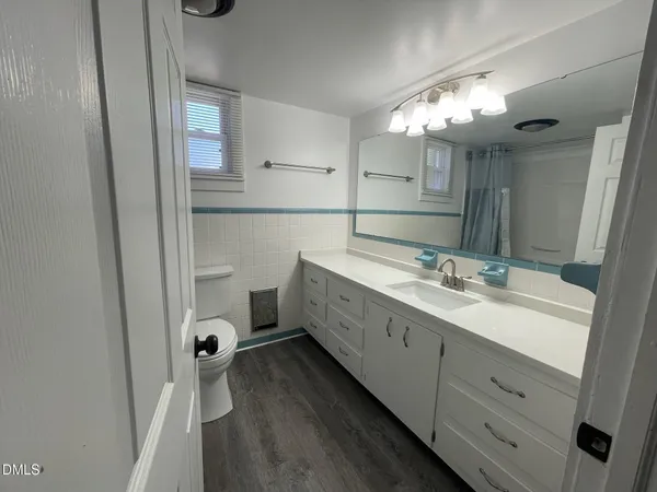 a bathroom with a double vanity sink mirror and shower