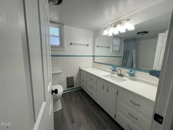 a bathroom with a double vanity sink mirror and shower