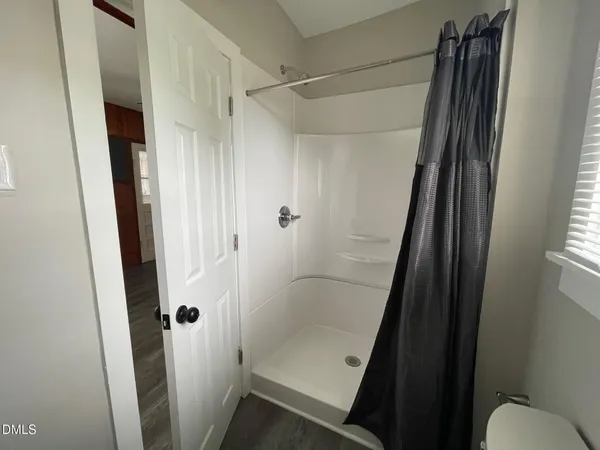 a bathroom with a shower and a tub