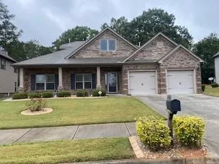 a front view of a house with swimming pool having outdoor seating