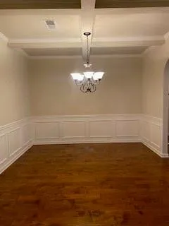 a view of a room with an empty space and a window