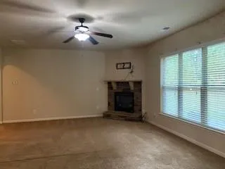 a view of a livingroom with a ceiling fan and window