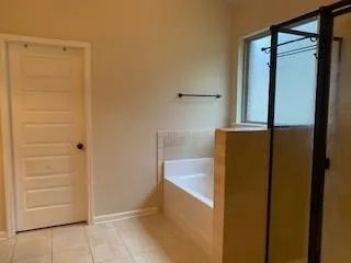 a bathroom with a tub and a shower