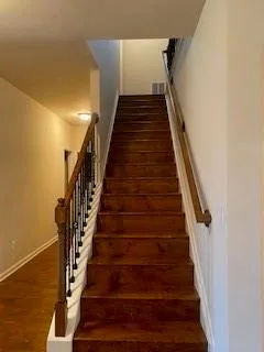 a view of an empty room with a chandelier fan
