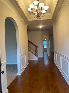 a view of entryway and hall with wooden floor