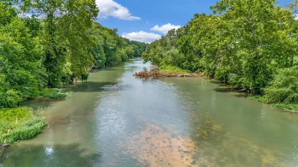 a view of a water pond with green space