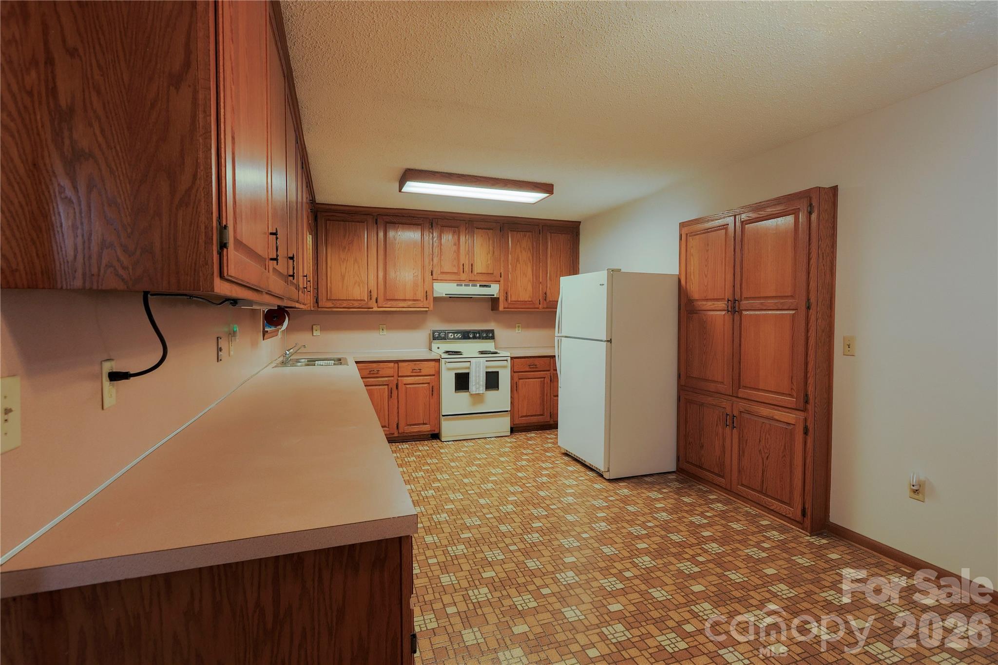 11237 Old Concord Road Rockwell, NC 28138 - Photo 9 of 30 a kitchen with a refrigerator a stove and wooden cabinets