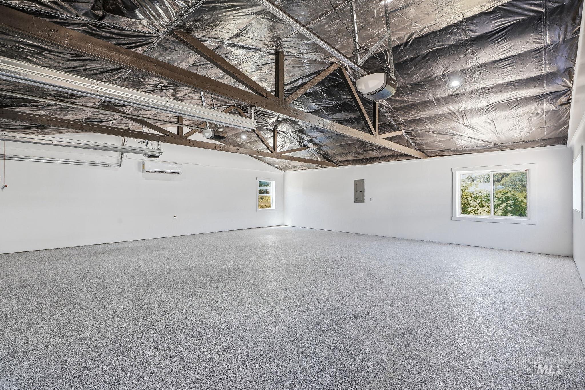 2152 Artesian Road Eagle, ID 83616 - Photo 32 of 50 Spacious interior featuring exposed wood ceiling trusses and a speckled epoxy floor