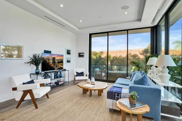 a living room with furniture a rug and a large window
