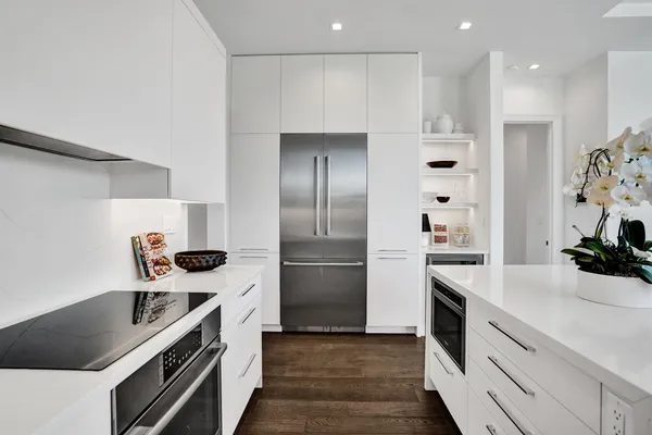 a kitchen with a stove a refrigerator and a sink
