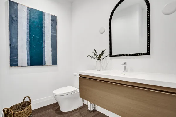 a bathroom with a toilet sink and mirror