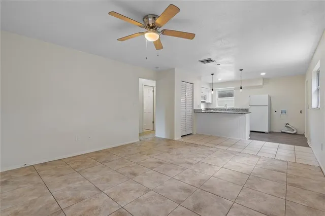 a view of a kitchen with a sink and a chandelier fan