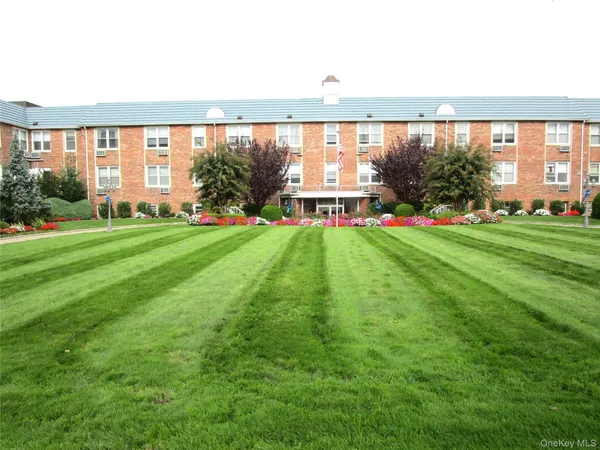 a view of pool with a big yard and large trees