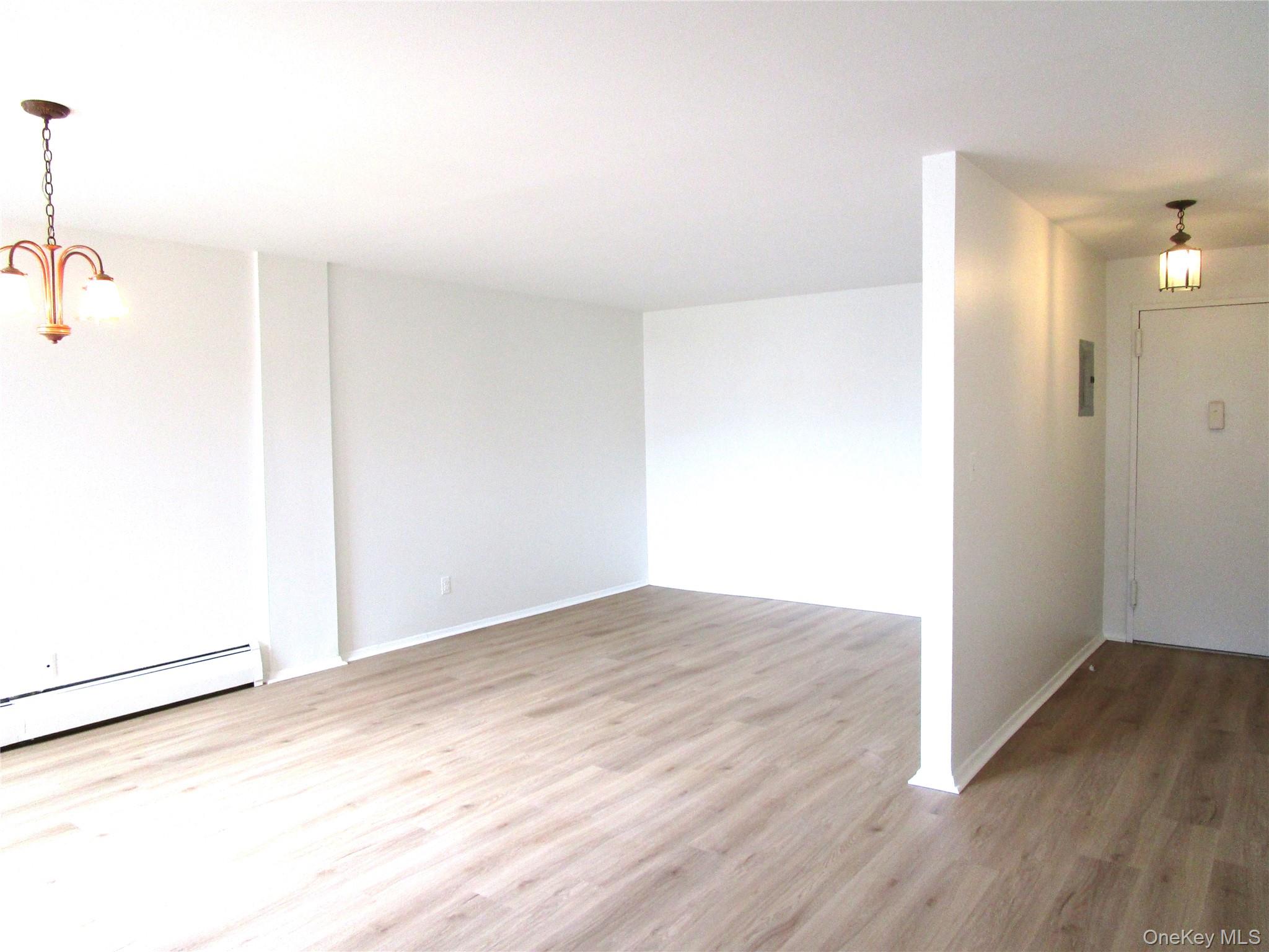 75 Noble Street, Unit 126 Lynbrook, NY 11563 - Photo 11 of 36 a view of empty room with wooden floor