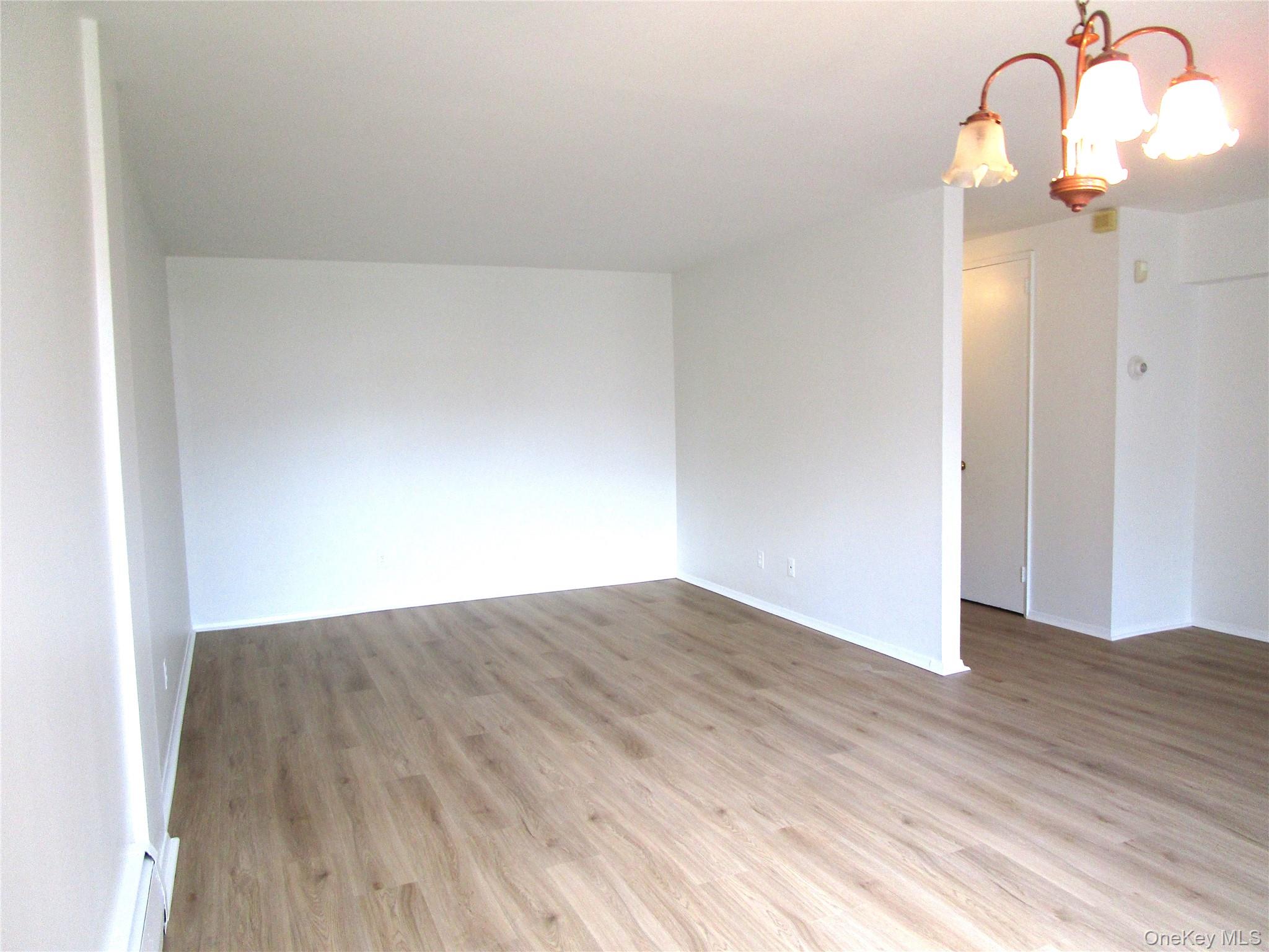 75 Noble Street, Unit 126 Lynbrook, NY 11563 - Photo 12 of 36 a view of a room with wooden floor