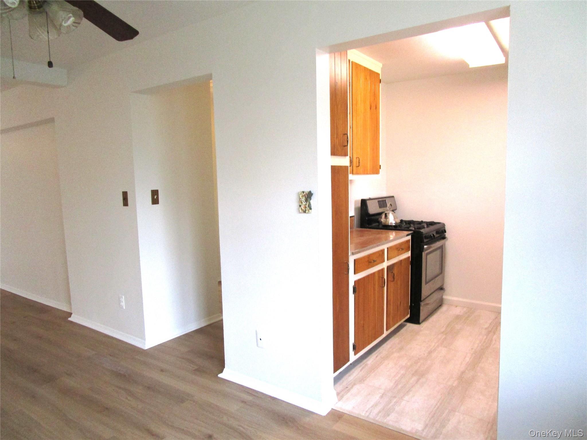 75 Noble Street, Unit 126 Lynbrook, NY 11563 - Photo 14 of 36 a kitchen with stainless steel appliances granite countertop a refrigerator and a stove top oven