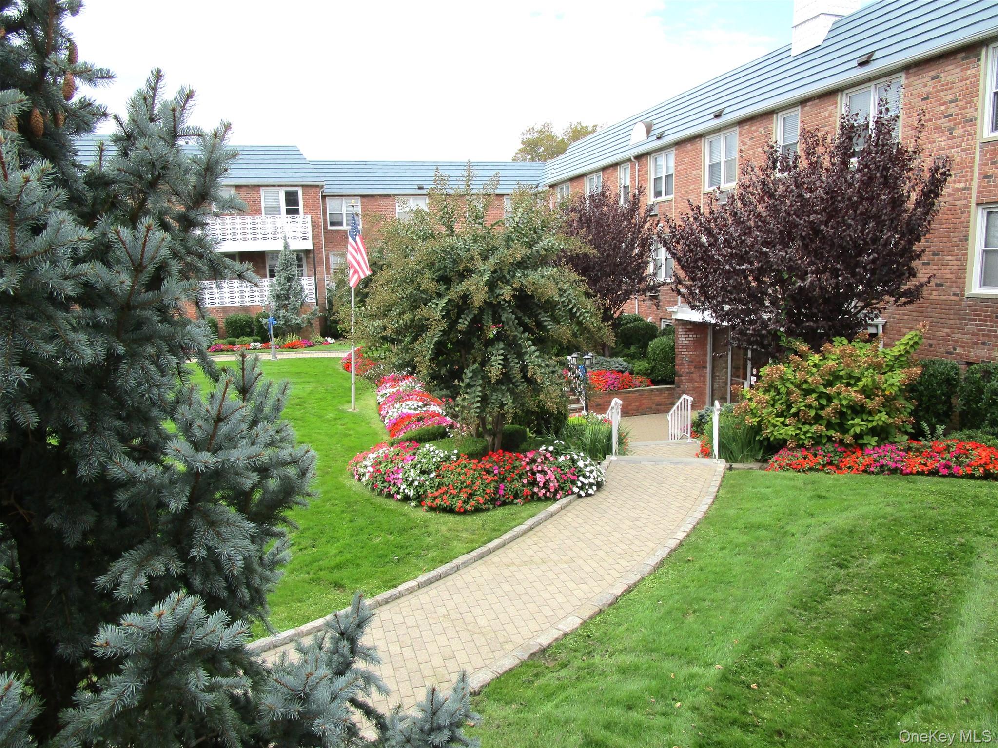 75 Noble Street, Unit 126 Lynbrook, NY 11563 - Photo 19 of 36 a view of a garden with a flower garden