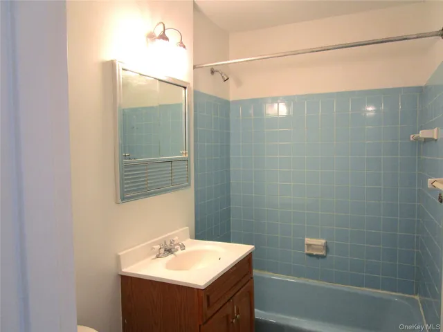 a white toilet sitting next to a bathroom sink