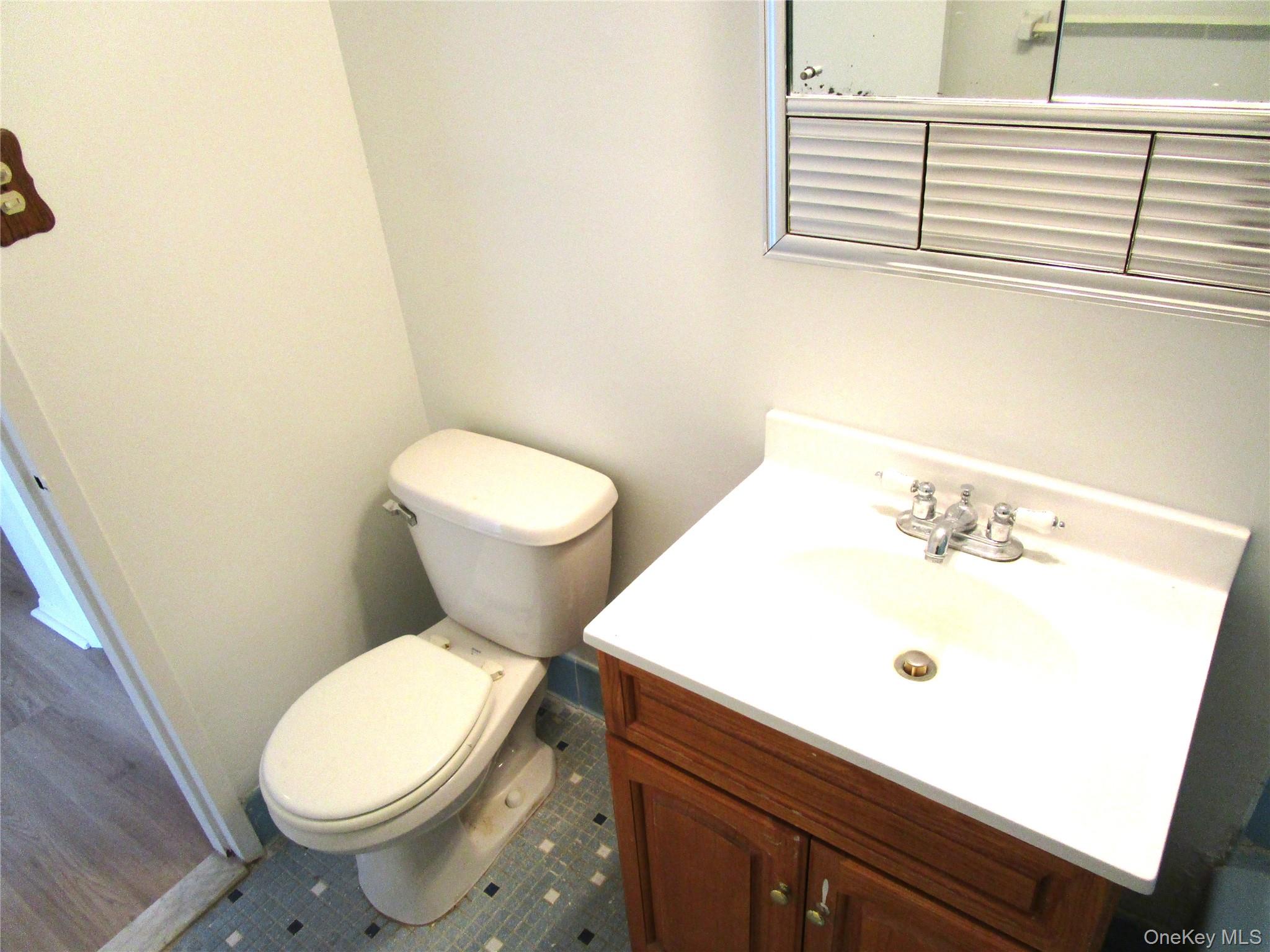 75 Noble Street, Unit 126 Lynbrook, NY 11563 - Photo 23 of 36 a white toilet sitting next to a bathroom sink